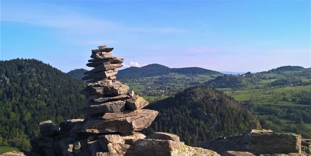 a stack of rocks on top of a mountain at Bulle de Bois, écolodge insolite avec spa privatif au milieu des volcans - Bulles d&#39;Herbe in Queyrières