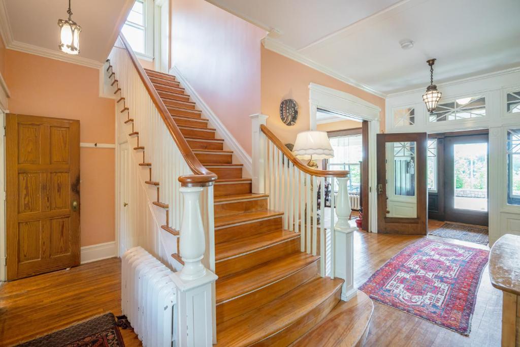 a staircase in a home with wooden floors at Lion's Head B&B in Niagara Falls