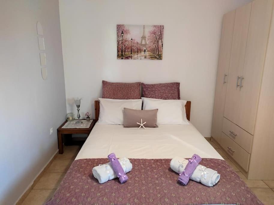 a bedroom with a bed with two slippers on it at Petra House in Petra