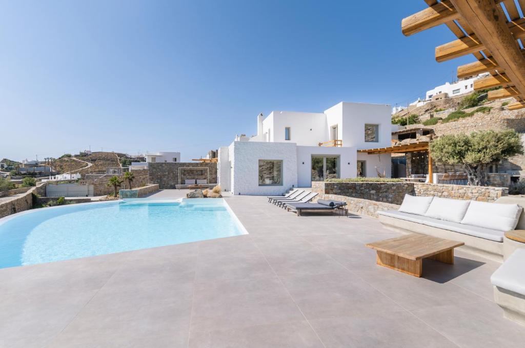a villa with a swimming pool and a house at My Castle House - MG Villas Mykonos in Fanari