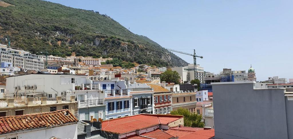a view of a city with buildings and a mountain at Gibraltar Town Centre Flat with Roof Terrace in Gibraltar