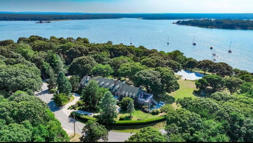 an aerial view of a house on an island in the water at Rams Head Inn in Shelter Island