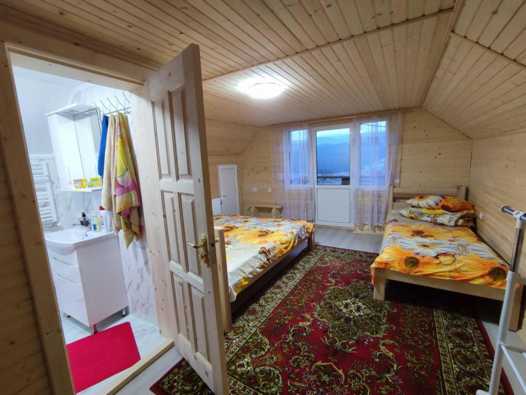 a small room with two beds and a bathroom at Гостинний двір Матійчуків Новий in Vorokhta