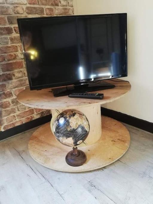 Televízia a/alebo spoločenská miestnosť v ubytovaní Le Nid douillet splendide Linge fourni