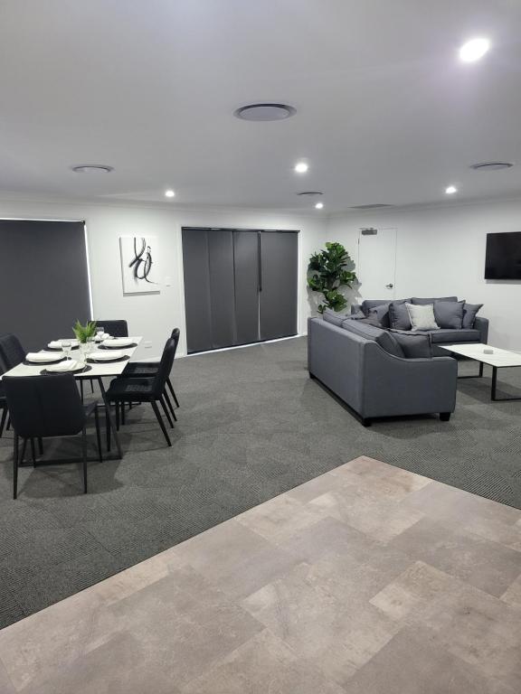 a living room with a couch and a table at CH Boutique Apartments The Ringers Road in Tamworth