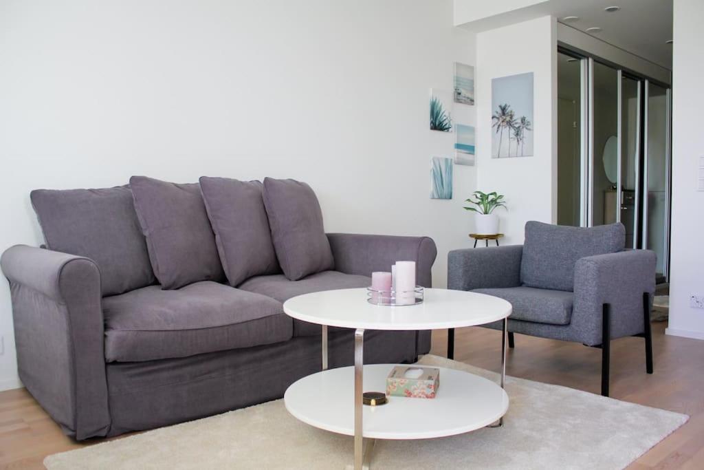 a living room with a couch and two chairs and a table at Modern apartment with Sauna, near Transit Hub/Dixi in Vantaa
