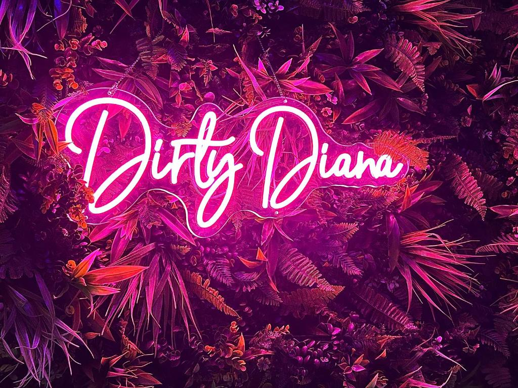 a neon sign that reads city planner in a forest at Love Room Suite Dirty Diana in Aubagne