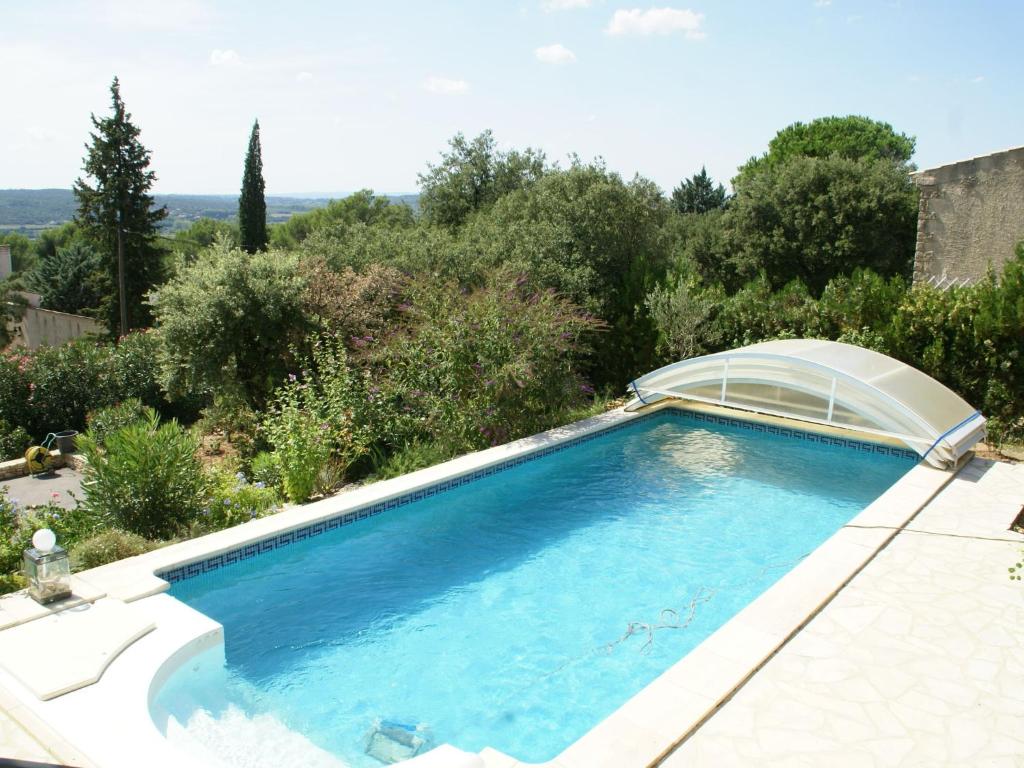 a swimming pool with an arvisor around it at Spacious holiday home with private pool in Saint-Maximin