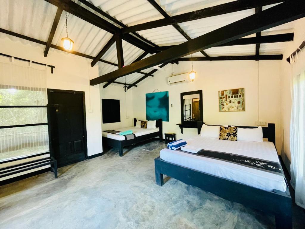 Postel nebo postele na pokoji v ubytování Hotel Sigiriya Kele