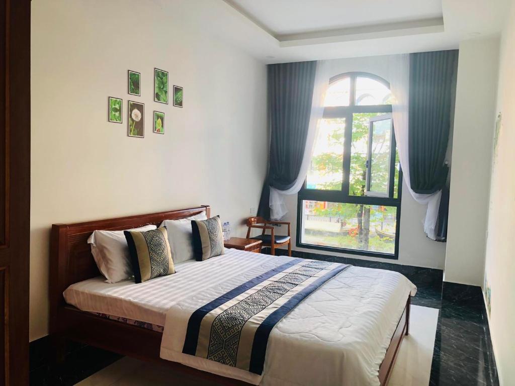 Postel nebo postele na pokoji v ubytování Coffee Pacific Grand World Phú Quốc