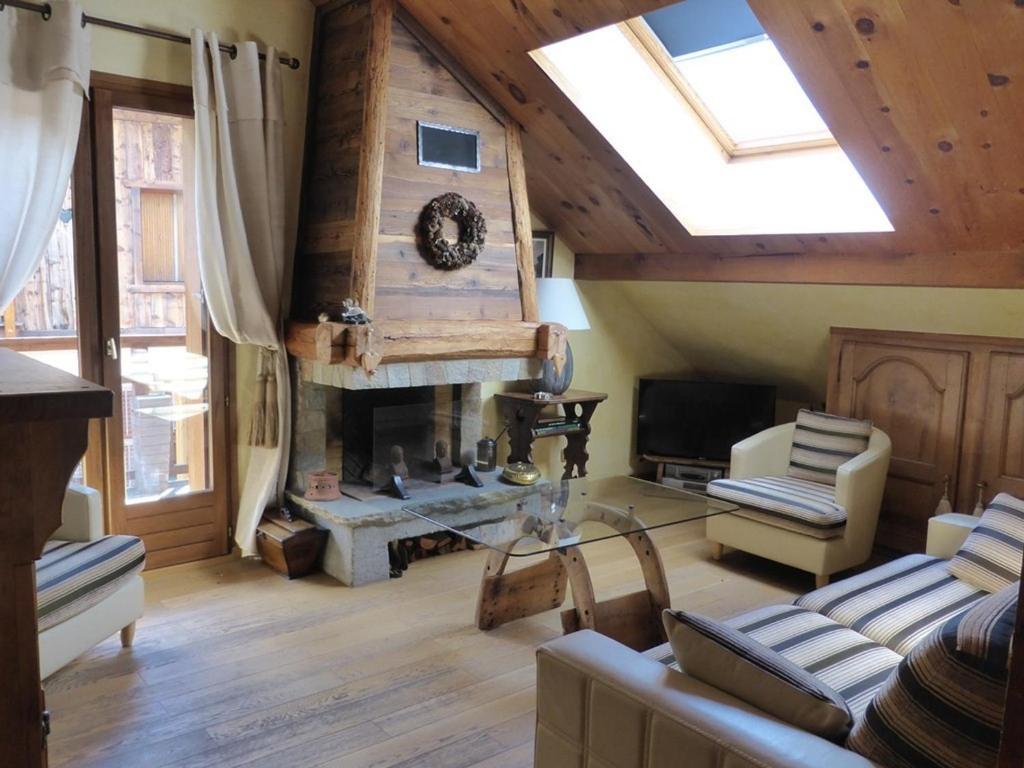 ein Wohnzimmer mit einem Kamin und einem Dachfenster in der Unterkunft Appartement Arêches-Beaufort, 3 pièces, 5 personnes - FR-1-342-297 in Beaufort