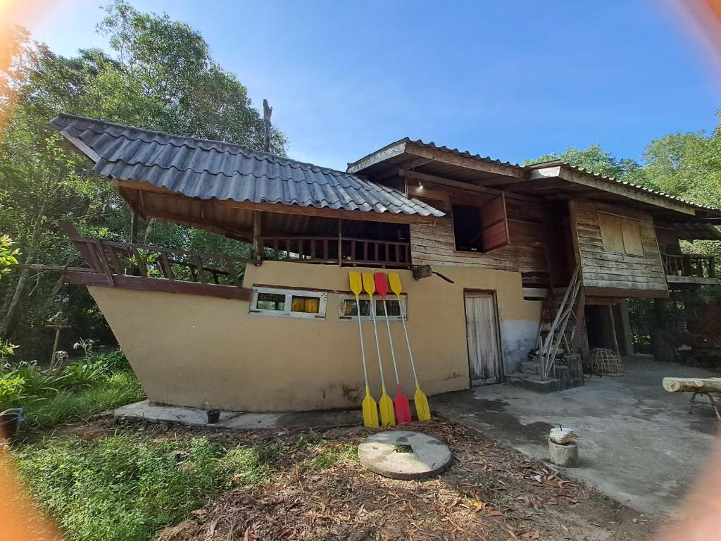 a house with a group of bats leaning against it at Big Hug Home in Ko Yao Noi