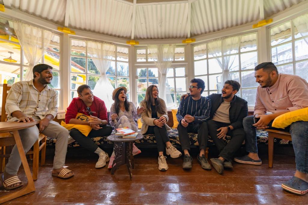 a group of people sitting in a room at The Hosteller Ooty in Ooty