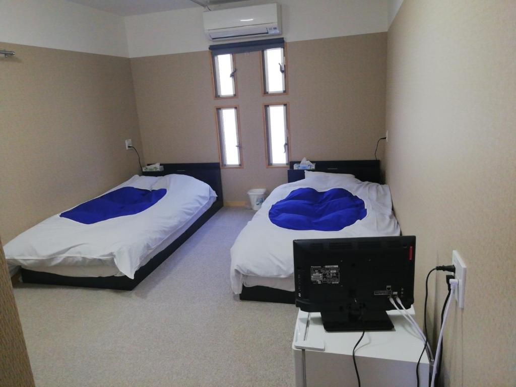 Giường trong phòng chung tại Naoshima Accommodation Menjuku Ura - Vacation STAY 23635v