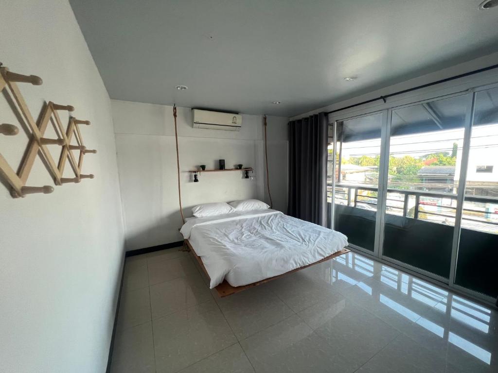 a bedroom with a bed and a large window at THE BEST ONE CHIANG MAI in Chiang Mai