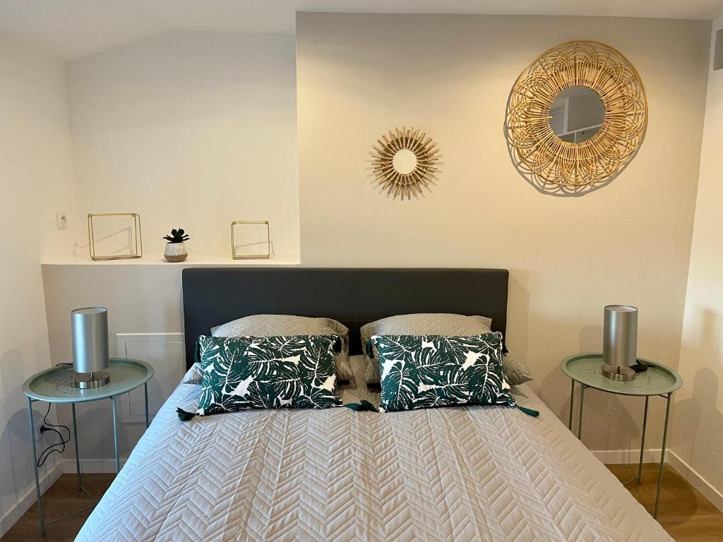 a bedroom with a bed with two tables at Appartement 2 chambres en plein centre ville in Chalon-sur-Saône