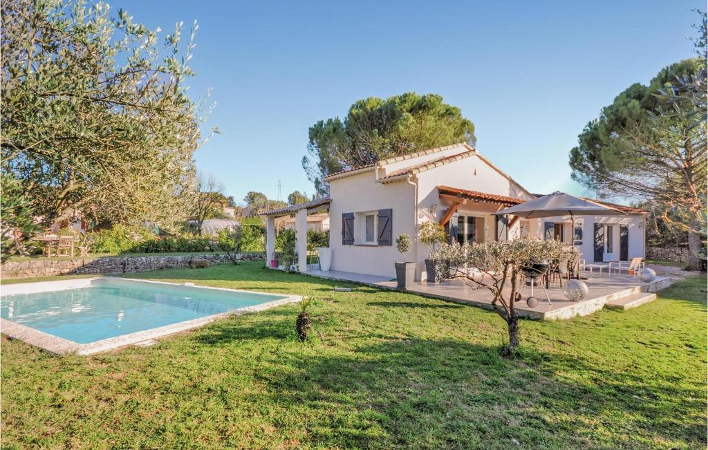 a house with a swimming pool in a yard at 3 Bedroom Lovely Home In Peymeinade in Peymeinade