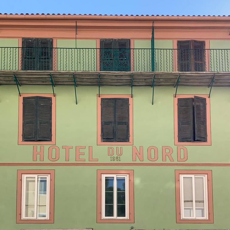 a hotel do notord sign on the side of a building at Hôtel du Nord in Corte