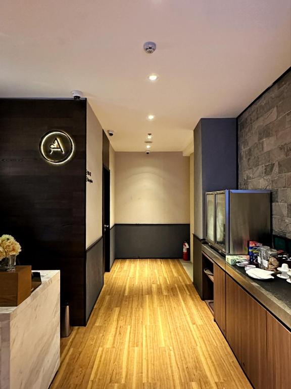 a room with a kitchen with a hard wood floor at Aerotel Cebu in Mactan