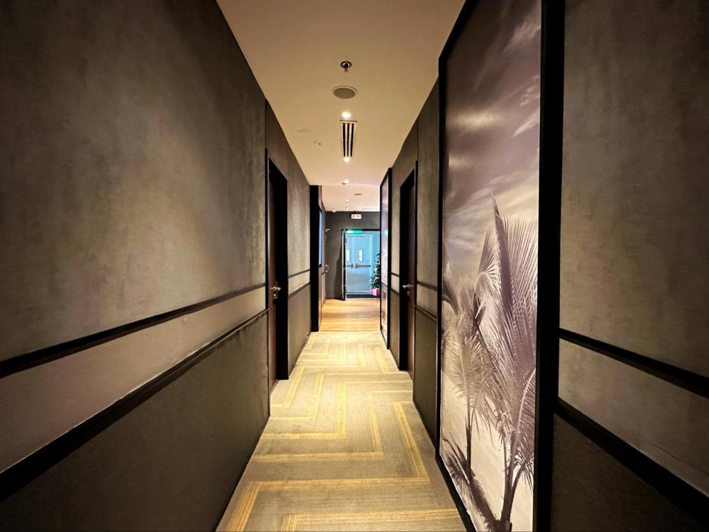 a long hallway with black walls and wooden floors at Aerotel Cebu in Mactan