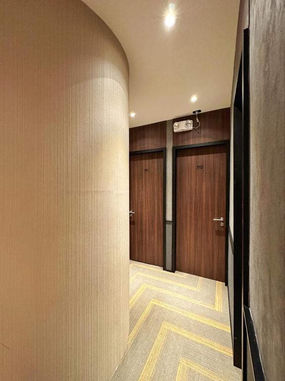 a hallway with wooden doors and a hallwayngth at Aerotel Cebu in Mactan