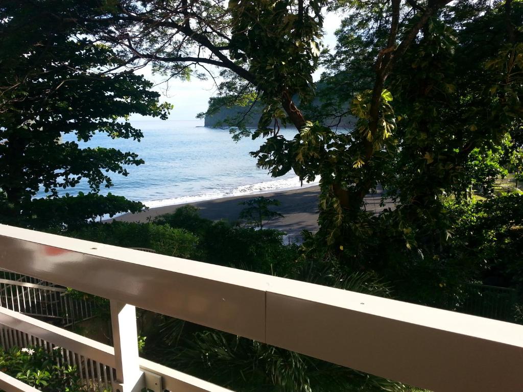 a view of the beach from a balcony at Toupidek-sur-la-Plage in Arue