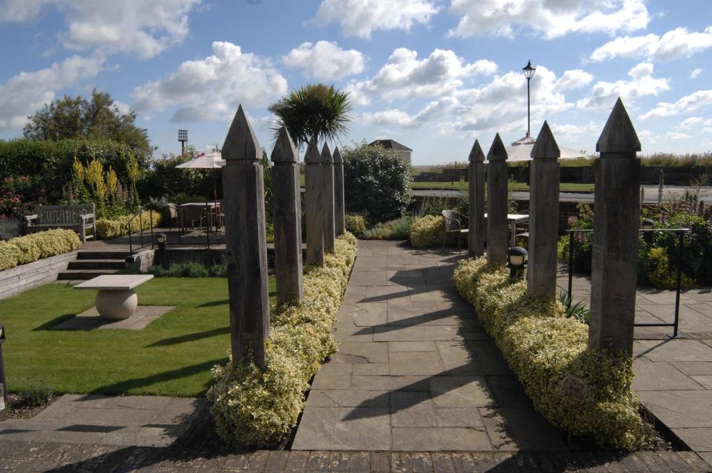 a row of wooden posts in a park at Wentworth Hotel in Aldeburgh
