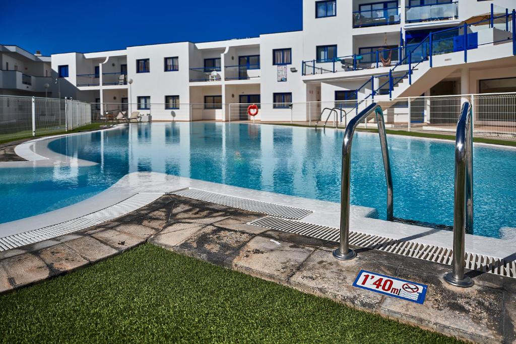 an empty swimming pool in front of a building at CostaSun and Pool in Costa Calma