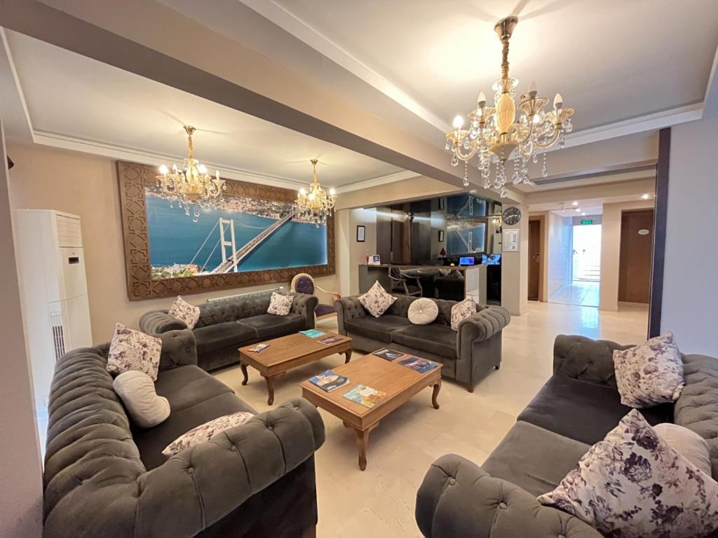 a living room with couches and a chandelier at Elite Marmara Bosphorus&Suites in Istanbul