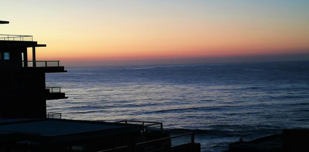 a view of the ocean at sunset from a building at 7 Vallen Lodge in Ballito