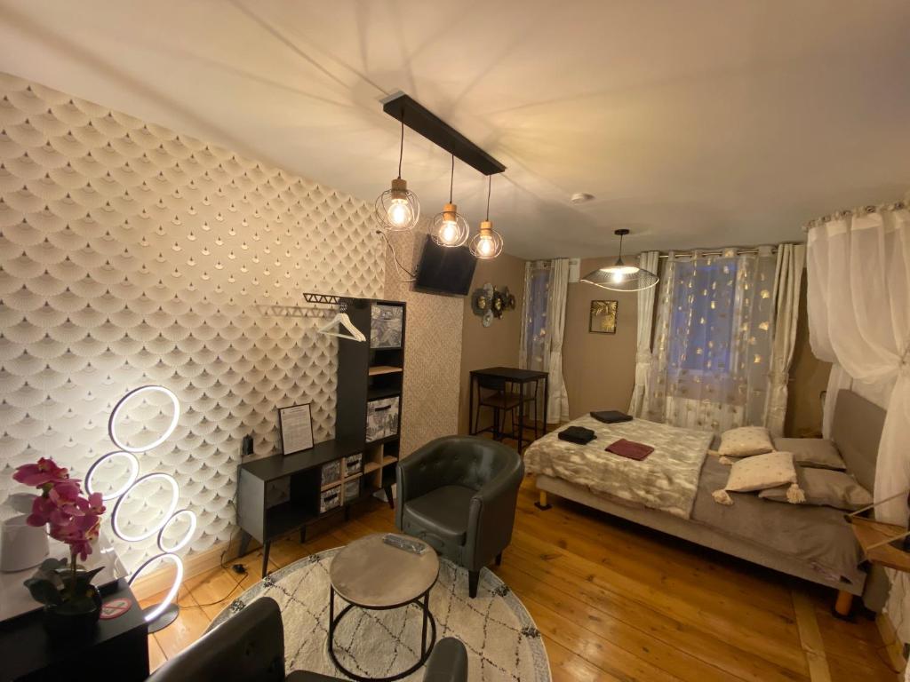 a bedroom with a bed and a desk and a couch at Chambre D'hôte Villa Maurice in Étretat