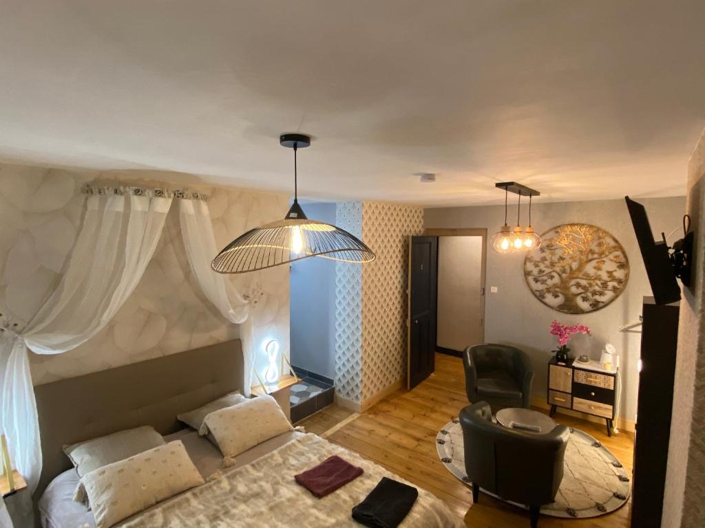 a living room with a bed and a chair at Chambre D'hôte Villa Maurice in Étretat