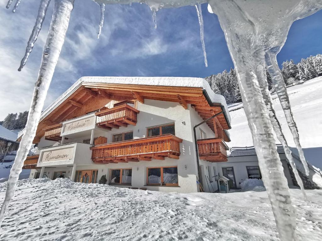 a building in the snow with icicles hanging from it at Residence Rumanon in Ortisei