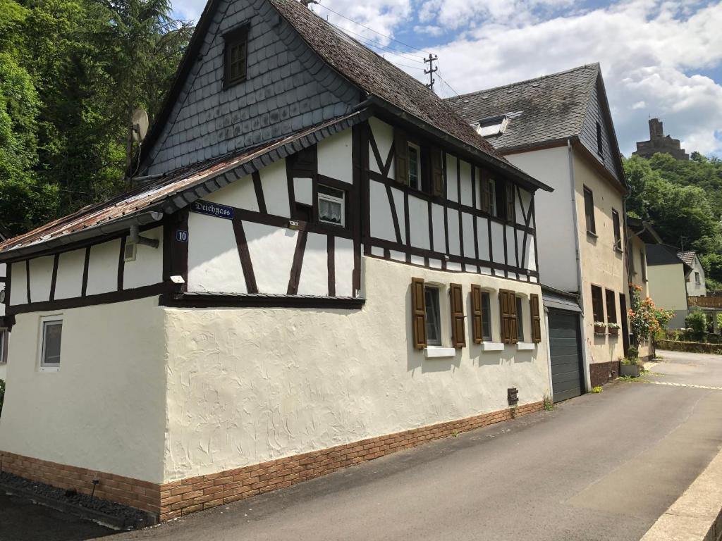 an old black and white building on a street at Ferienhaus Ehrbachklamm in Brodenbach