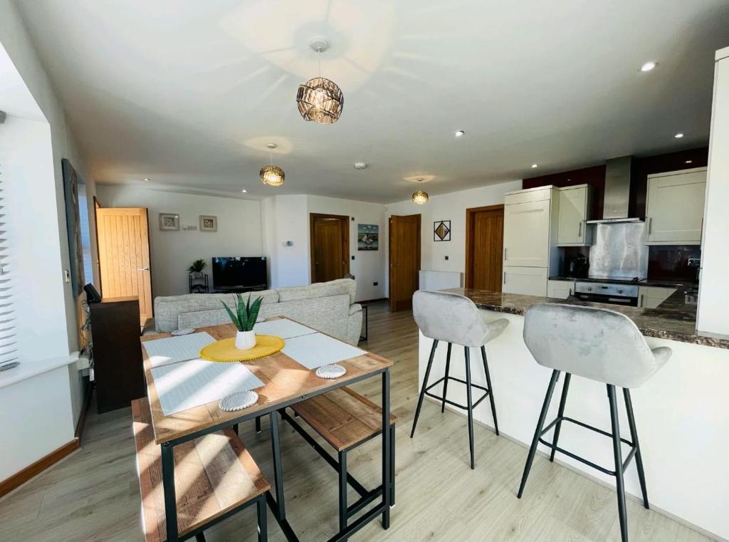 a kitchen and living room with a table and chairs at The Priory - 1 mile from Ramside Hall Hotel Spa and Golf & A1 in Durham