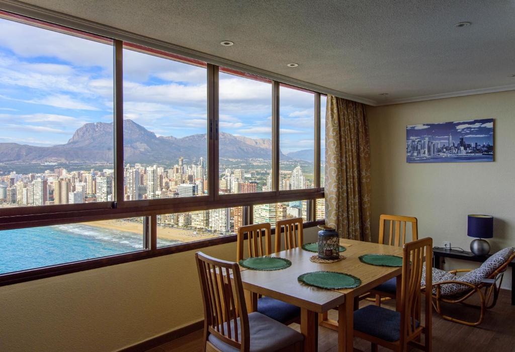 a dining room with a table and a large window at Sun&Beach View Apartments in Benidorm
