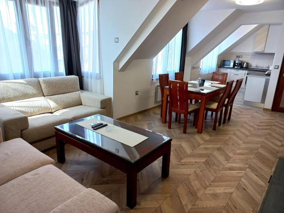a living room with a couch and a table and chairs at APARTMENT TONI / 2BEDROOMS in Varna City