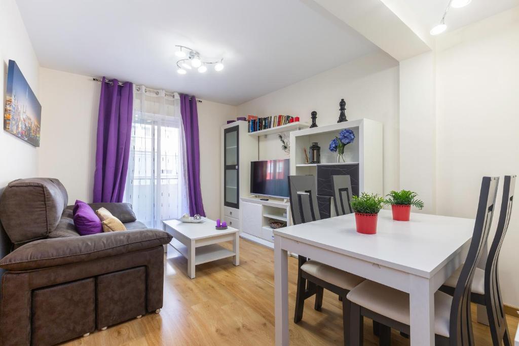 a living room with a table and a dining room at Apartamento Puente de Segovia in Madrid
