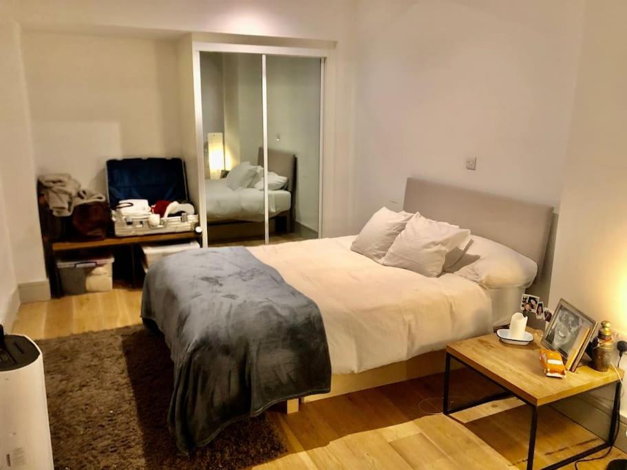 a bedroom with a large bed and a table at Cheviot House in London