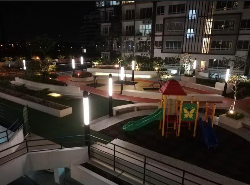 a park with a playground at night with lights at Homestay P residence 3 bedroom and 2 bathroom in Kuching