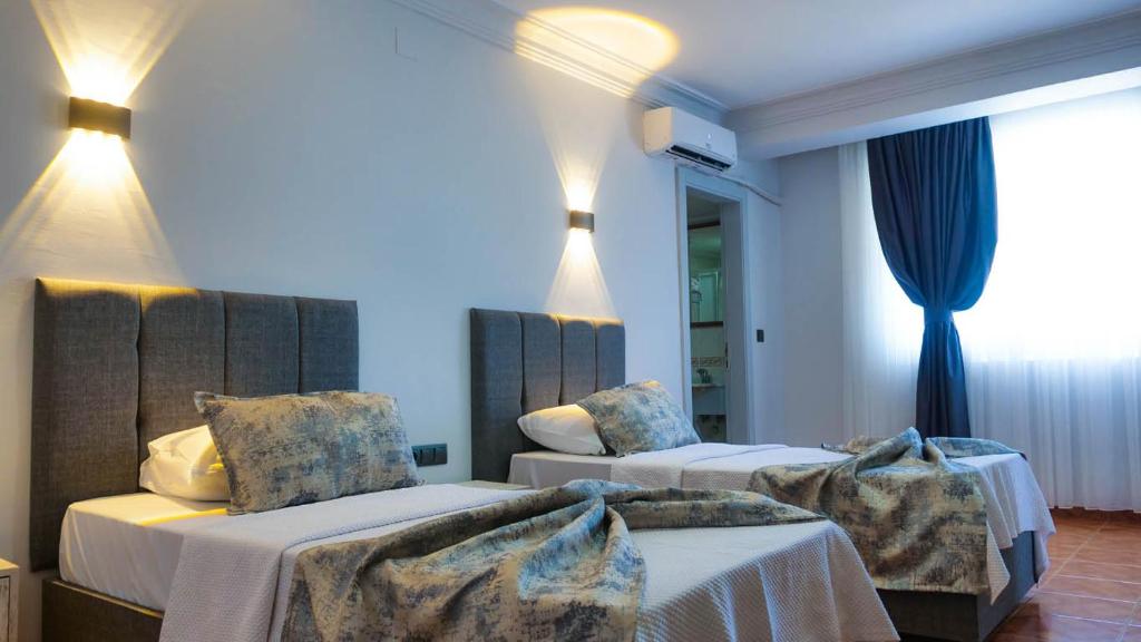 Ένα ή περισσότερα κρεβάτια σε δωμάτιο στο DIVA TURKA BEACH HOTEL