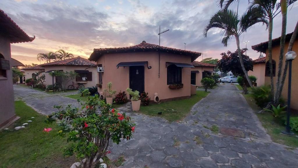 a house with a pathway leading to a yard at Chalé com 2 quartos a Beira Mar in Rio das Ostras