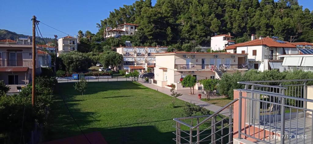 a view from the balcony of a house with a yard at Lemonis House in Nea Skioni