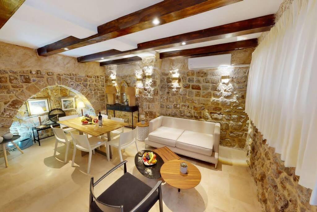 a living room with a couch and a table at The house in the Ramchal in Acre