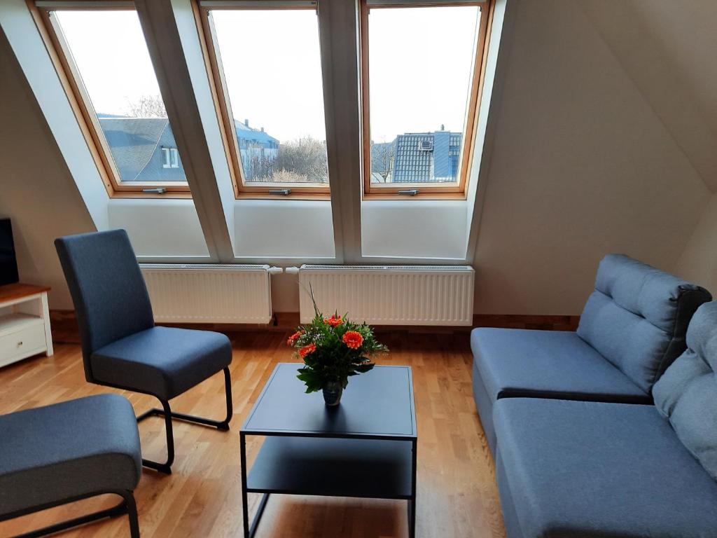 a living room with a couch and two chairs and a table at cosy home in Dresden