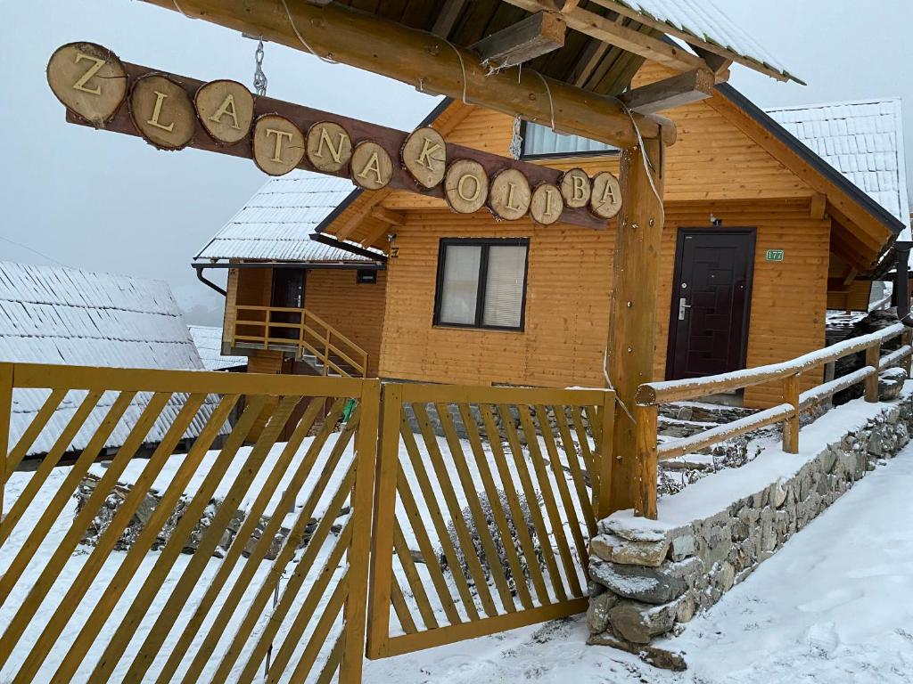 a cabin in the snow with a wooden fence at Zlatna koliba Namir Zuka in Fojnica