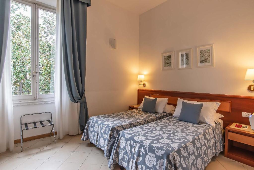 Postel nebo postele na pokoji v ubytování Hotel Bonifacio