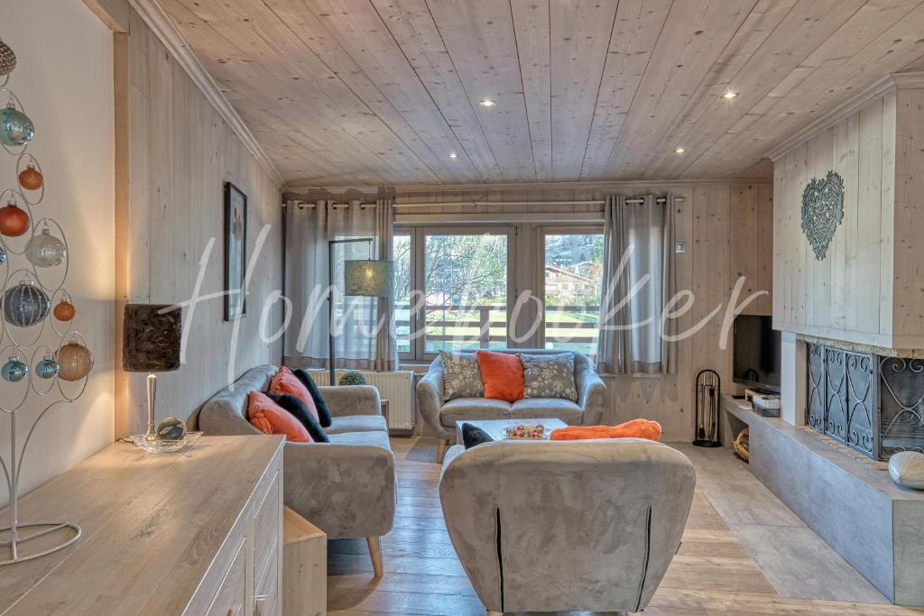 a living room with couches and a fireplace at Appartement Amour in Megève