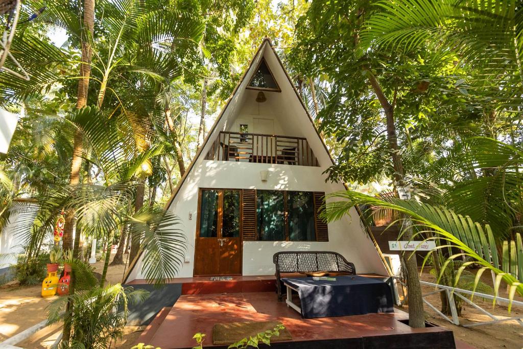 a small house in the middle of trees at DreamCatcher Unique Retreat Yoga & Spa in Palolem