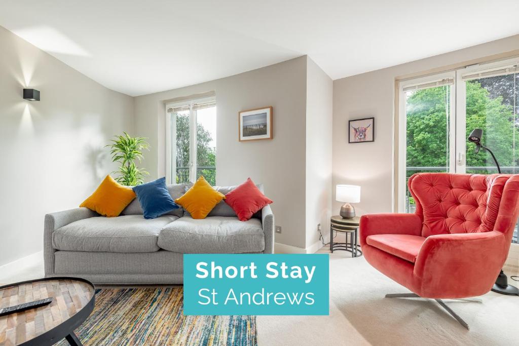 a living room with a couch and a chair at The Argyle Apartment - Luxury - Parking in St Andrews